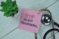 STOP High Cholesterol write on sticky notes isolated on Wooden Table Royalty Free Stock Photo