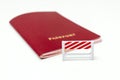 Stop illegal migration concept, red biometric international passport with a road barrier on white background