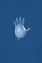 Stop infection. Inflated blue sterile glove isolated on blue navy background