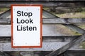 Stop look listen safety road sign at railway train station danger warning sign Royalty Free Stock Photo