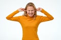 Young teenager female making wry face, plugging ears with fingers Royalty Free Stock Photo