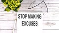 STOP MAKING EXCUSES text concept write on notebook on wooden background Royalty Free Stock Photo