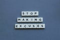 ' Stop Making Excuses ' word made of square letter word on grey background