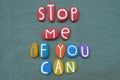 Stop me if you can, creative logo composed with multi colored stone letters over green sand