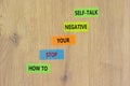 Stop negative self-talk symbol. Concept words How to stop your negative self-talk on colored paper. Beautiful wooden table wooden