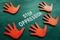 Stop oppression concept. Red hands and phrase.