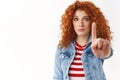 Stop please. Timid serious-looking redhead cute girl gather courage extend index finger taboo prohibition gesture