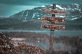 Stop polluting our world text quote engraved on wooden signpost outdoors in landscape looking polluted Royalty Free Stock Photo