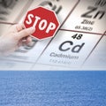 Stop pollution from dangerous cadmium and heavy metals in seawater - concept with hand holding a stop sign against a cadmium