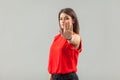 Stop! Portrait of serious beautiful brunette young woman in red shirt standing with stop hand sign gesture and looking at camera.