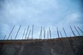 Stop. Prison. Protected location. Concrete wall with metal pins. Private property. Dark stormy sky. Copy space for text