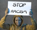 Stop racism black activist girl protesting against government - young beautiful and furious African American woman showing protest