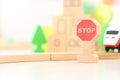 Stop road sign on the background of the children kit of a wooden toy city. railway in the children`s room. Teaching children t Royalty Free Stock Photo