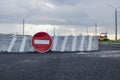 A stop road sign and concrete blocks block the entrance to the construction site. Closed road. Construction and road works Royalty Free Stock Photo