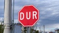 Stop road sign in Turkish - DUR - on a cloudy day