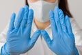 Stop SARS-CoV, SARSCoV, virus 2020 , MERS-CoV ,chinese virus COVID-19. Closeup womans hands in blue medical gloves show STOP sign