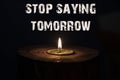 Stop saying tomorrow - white candle with dark background - in a