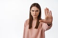 Stop it. Serious and determined woman extend palm and say no, forbid and disagree, condemn smth bad, forbid and reject Royalty Free Stock Photo