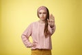 Stop it. Serious-looking confident focused young cute girl extending arm hold, tresspass gesture, frowning displeased Royalty Free Stock Photo