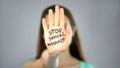 Stop sexual assault sign on womans hand, female rights protection, awareness