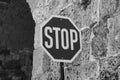 Stop sign against a brick stone wall in black and white Royalty Free Stock Photo