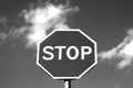 Stop sign against cloudy sky in black and white. Royalty Free Stock Photo