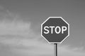 Stop sign against cloudy sky in black and white. Royalty Free Stock Photo