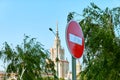 Stop sign on background of blue sky and silhouette of famous university in Moscow