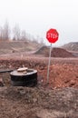 Stop sign and black drain on the red ground Royalty Free Stock Photo