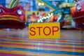 Stop sign with carnival festival blurred Carousel background