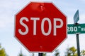 Stop Sign on a country road with trees during summer Royalty Free Stock Photo