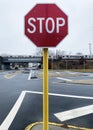 Stop sign by dangerous intersection with train tressel in background