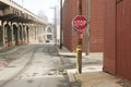 Stop sign in empty street along bridge