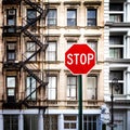 Stop Sign in front of Old Buildings in New York City Royalty Free Stock Photo