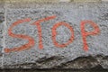 Stop sign. graffiti lettering of the word stop on the stone granite wall. Royalty Free Stock Photo