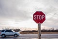 Stop Sign at an Intersection along a Highway at Sunset Royalty Free Stock Photo