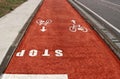 Stop sign painted on the ground in a red two lane cycle path Royalty Free Stock Photo