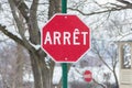 Stop sign from Quebec in French in winter