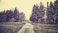 Stop sign at railway crossing in a rural landscape. Royalty Free Stock Photo