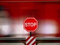Stop sign in red against moving train blurry Royalty Free Stock Photo