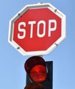 Stop sign and red light at the road crossing Royalty Free Stock Photo