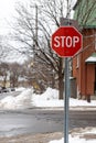 Stop sign in a residential neighborhood at crossroads in winter.