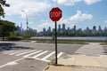 Stop Sign on the East River Riverfront of Astoria Queens New York with the Roosevelt Island and Manhattan Skyline during Summer Royalty Free Stock Photo