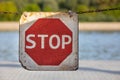 Stop sign on suspended chain. Road sign to warn to stop. Background with nature and vegetation Royalty Free Stock Photo