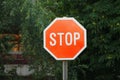 Stop sign with trees in background