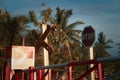 Stop signs and rail crossings and coconut trees in the morning