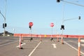 Stop signs and various warning signs warning oncoming traffic of the end of the road on a highway still under construction in Royalty Free Stock Photo