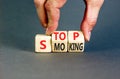 Stop smoking symbol. Concept words Stop smoking on wooden cubes. Beautiful grey table grey background. Doctor hand. Medical, Royalty Free Stock Photo