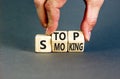 Stop smoking symbol. Concept words Stop smoking on wooden cubes. Beautiful grey table grey background. Doctor hand. Medical, Royalty Free Stock Photo