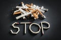 Stop smoking written with broken matches and cigarettes